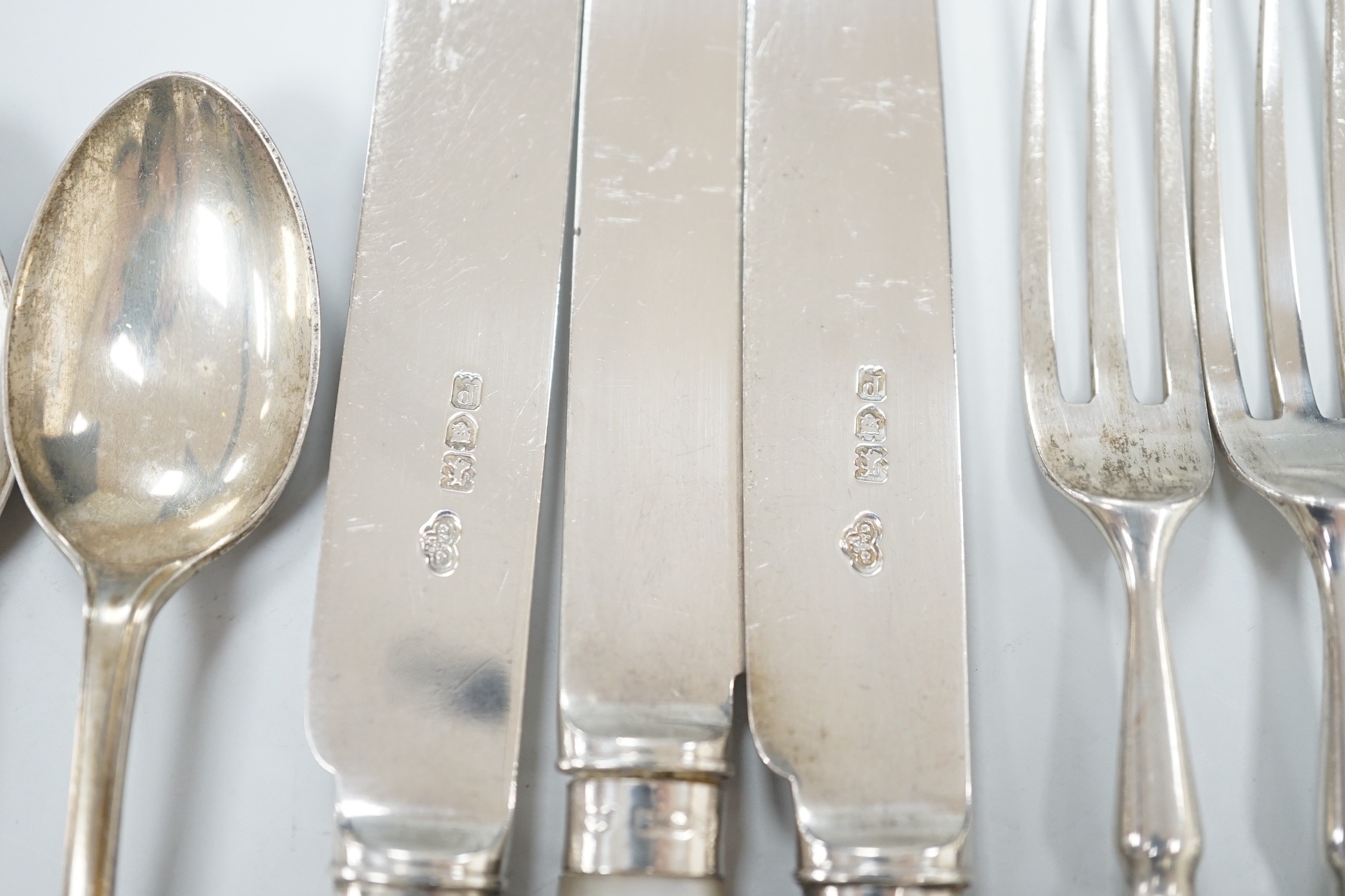 A set of six George V golfing related teaspoons, Walker & Hall, Sheffield, 1933 and seven mother of pearl handled silver dessert eaters.